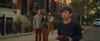 Movie still from “Lyle, Lyle, Crocodile” (2022), directed by Will Speck – A group of people standing on a sidewalk; Medium shot, Over the shoulder angle