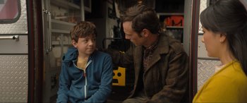 Movie still from “Lyle, Lyle, Crocodile” (2022), directed by Will Speck – A man and a boy sitting next to each other; Medium shot, Over the shoulder angle