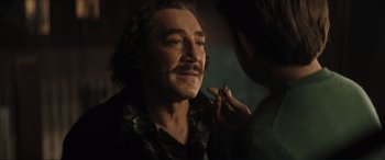 Movie still from “Lyle, Lyle, Crocodile” (2022), directed by Will Speck – A man with long hair and a mustache is looking at a woman; Close Up shot, Low angle