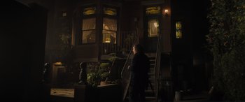 Movie still from “Lyle, Lyle, Crocodile” (2022), directed by Will Speck – A person walking down a set of stairs at night; Wide shot, Over the shoulder angle