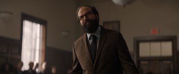 Movie still from “Lyle, Lyle, Crocodile” (2022), directed by Will Speck – A man in a suit and tie standing in a room; Medium shot, Low angle