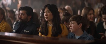 Movie still from “Lyle, Lyle, Crocodile” (2022), directed by Will Speck – A group of people sitting in front of a crowd; Medium shot, Over the shoulder angle