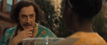 Movie still from “Lyle, Lyle, Crocodile” (2022), directed by Will Speck – A man in a blue and yellow jacket talking to a woman; Close Up shot, Over the shoulder angle