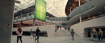 Movie still from “M3GAN” (2022), directed by Gerard Johnstone – People are walking in an atrium of a building; Extreme Wide shot, High angle