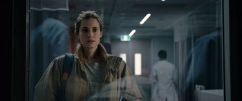 Movie still from “M3GAN” (2022), directed by Gerard Johnstone – A woman standing in front of a glass window; Close Up shot, Over the shoulder angle