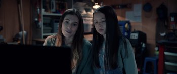 Movie still from “M3GAN” (2022), directed by Gerard Johnstone – Two young women looking at a laptop computer screen; Close Up shot, Over the shoulder angle
