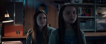 Movie still from “M3GAN” (2022), directed by Gerard Johnstone – A woman standing next to another woman in front of a mirror; Close Up shot, Over the shoulder angle