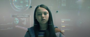 Movie still from “M3GAN” (2022), directed by Gerard Johnstone – A young girl with long black hair is looking at the camera; Close Up shot, High angle