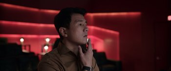 Movie still from “M3GAN” (2022), directed by Gerard Johnstone – A man in a brown shirt is touching his face; Close Up shot, Low angle