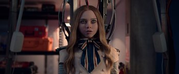 Movie still from “M3GAN” (2022), directed by Gerard Johnstone – A woman with long red hair wearing a suit and tie; Close Up shot, Low angle