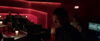 Movie still from “M3GAN” (2022), directed by Gerard Johnstone – A man looking at his cell phone in a dark room; Medium shot, Low angle
