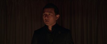 Movie still from “M3GAN” (2022), directed by Gerard Johnstone – A man wearing a suit and tie in the dark; Close Up shot, Low angle