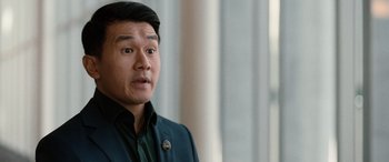 Movie still from “M3GAN” (2022), directed by Gerard Johnstone – A person wearing a suit and tie; Close Up shot, Over the shoulder angle