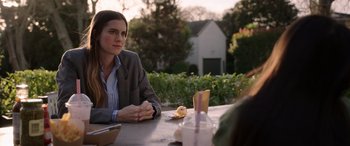 Movie still from “M3GAN” (2022), directed by Gerard Johnstone – A woman sitting at a table in front of a sandwich; Medium shot, Over the shoulder angle