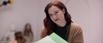 Movie still from “M3GAN” (2022), directed by Gerard Johnstone – A beautiful woman with red hair holding a piece of paper; Close Up shot, Over the shoulder angle