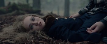 Movie still from “M3GAN” (2022), directed by Gerard Johnstone – A woman laying on the ground with her eyes closed; Close Up shot, High angle