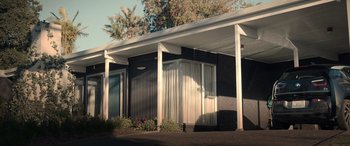 Movie still from “M3GAN” (2022), directed by Gerard Johnstone – A black and white building with a white awning; Extreme Wide shot, Low angle