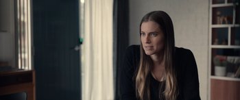 Movie still from “M3GAN” (2022), directed by Gerard Johnstone – A woman with long hair sitting in front of a window; Close Up shot, Over the shoulder angle