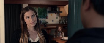 Movie still from “M3GAN” (2022), directed by Gerard Johnstone – A woman standing in front of another woman in a kitchen; Close Up shot, Over the shoulder angle