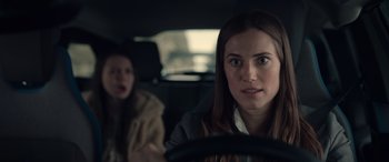Movie still from “M3GAN” (2022), directed by Gerard Johnstone – Two women in the back seat of a car; Close Up shot, Over the shoulder angle
