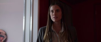 Movie still from “M3GAN” (2022), directed by Gerard Johnstone – A woman with long brown hair standing in front of a window; Close Up shot, Low angle