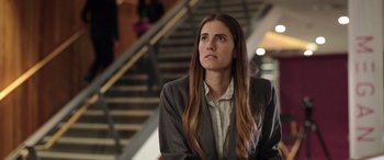 Movie still from “M3GAN” (2022), directed by Gerard Johnstone – A woman in a business suit looking up at the sky; Close Up shot, Low angle