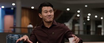 Movie still from “M3GAN” (2022), directed by Gerard Johnstone – A man in a maroon shirt is smiling; Close Up shot, Over the shoulder angle