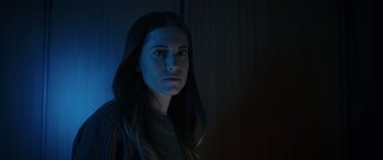 Movie still from “M3GAN” (2022), directed by Gerard Johnstone – A woman with long black hair stares into the camera; Close Up shot, Low angle