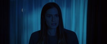 Movie still from “M3GAN” (2022), directed by Gerard Johnstone – A woman with long dark hair stares at the camera; Close Up shot, Over the shoulder angle