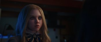Movie still from “M3GAN” (2022), directed by Gerard Johnstone – A woman with long blonde hair wearing a bow tie; Close Up shot, Over the shoulder angle