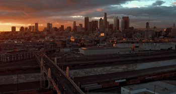 Movie still from “Mack & Rita” (2022), directed by Katie Aselton – A view of a city at sunset from above; Extreme Wide shot, High angle