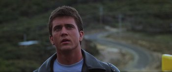 Movie still from “Mad Max” (1979), directed by George Miller – A person wearing a leather jacket; Close Up shot, Low angle