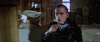 Movie still from “Mad Max” (1979), directed by George Miller – A man in a leather jacket holding a pair of headphones; Close Up shot, Low angle