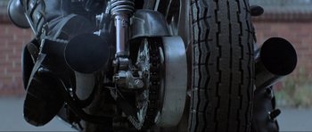 Movie still from “Mad Max” (1979), directed by George Miller – View of the front wheel of a motorcycle; Extreme Close Up shot, Low angle