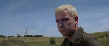 Movie still from “Mad Max” (1979), directed by George Miller – A person wearing a shirt; Close Up shot, Low angle