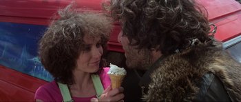 Movie still from “Mad Max” (1979), directed by George Miller – A man and a woman sharing a cone of ice - cream; Close Up shot, Over the shoulder angle