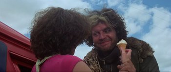 Movie still from “Mad Max” (1979), directed by George Miller – A man and a woman looking into each others eyes; Close Up shot, Low angle