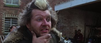 Movie still from “Mad Max” (1979), directed by George Miller – A person wearing a jacket; Close Up shot, Low angle