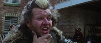 Movie still from “Mad Max” (1979), directed by George Miller – A person wearing a jacket; Close Up shot, Low angle