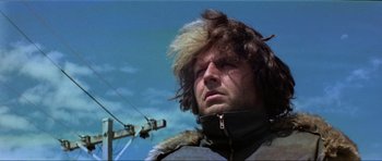 Movie still from “Mad Max” (1979), directed by George Miller – A person wearing a jacket; Close Up shot, Low angle