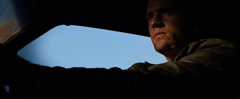 Movie still from “The Road Warrior” (1981), directed by George Miller – A man's face in the sunlight; Close Up shot, Low angle