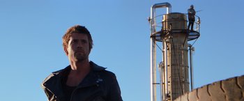 Movie still from “The Road Warrior” (1981), directed by George Miller – A person wearing a leather jacket; Close Up shot, Low angle