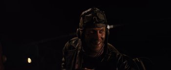 Movie still from “The Road Warrior” (1981), directed by George Miller – A man wearing a leather jacket and a helmet; Close Up shot, High angle