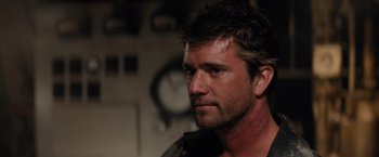 Movie still from “The Road Warrior” (1981), directed by George Miller – A person wearing a jacket; Close Up shot, Over the shoulder angle