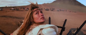 Movie still from “The Road Warrior” (1981), directed by George Miller – A person wearing a helmet; Close Up shot, Low angle