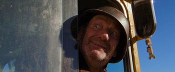 Movie still from “The Road Warrior” (1981), directed by George Miller – A person wearing a hat; Close Up shot, Low angle