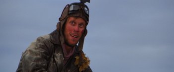 Movie still from “The Road Warrior” (1981), directed by George Miller – A person wearing a helmet; Close Up shot, Low angle