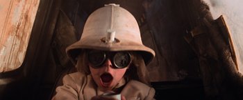 Movie still from “Mad Max Beyond Thunderdome” (1985), directed by George Miller – A young child wearing a helmet and goggles; Close Up shot, Low angle
