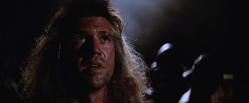 Movie still from “Mad Max Beyond Thunderdome” (1985), directed by George Miller – A person with long blonde hair; Close Up shot, Low angle