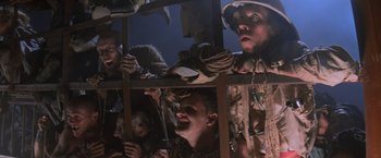 Movie still from “Mad Max Beyond Thunderdome” (1985), directed by George Miller – A group of people standing next to each other; Medium shot, Low angle